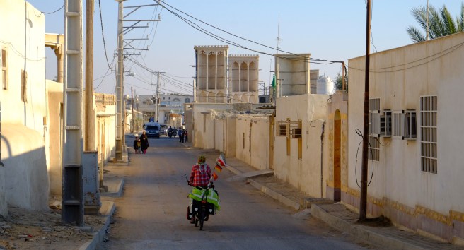 Cycling through an old fishermen's village famous for its many wind towers